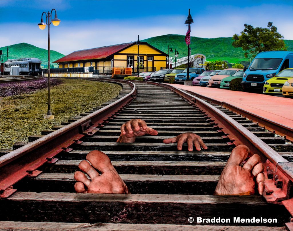 Train tracks with hands and feet producing between the ties