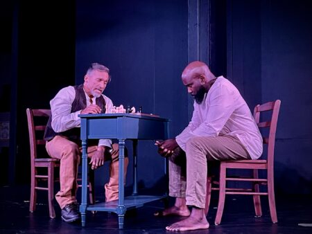 actors play chess on a small table